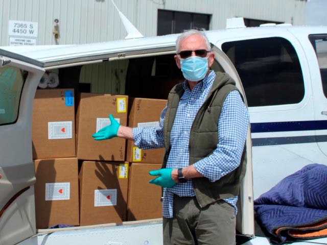 Man showing boxes loaded in airplane for Angel Flight