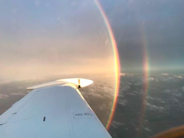 View of sky and wing from airplane window